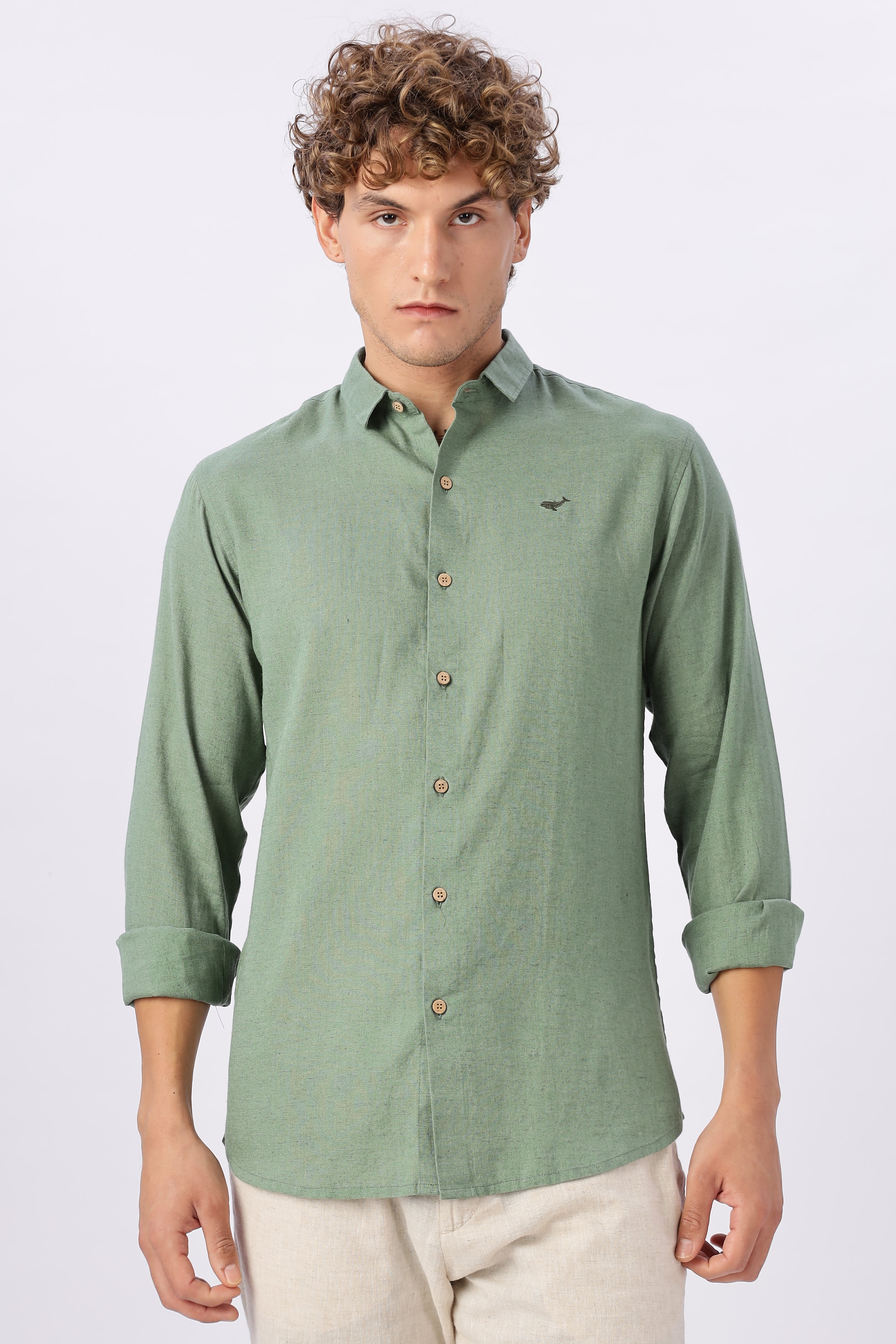 Man wearing a green button-up shirt with a collar on a white background